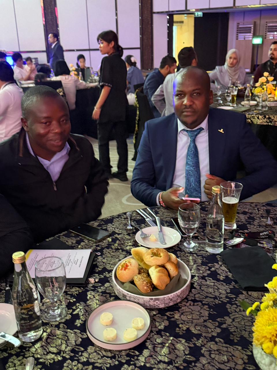A dinner conversation moment that reflects the relationships and connections built around the event.